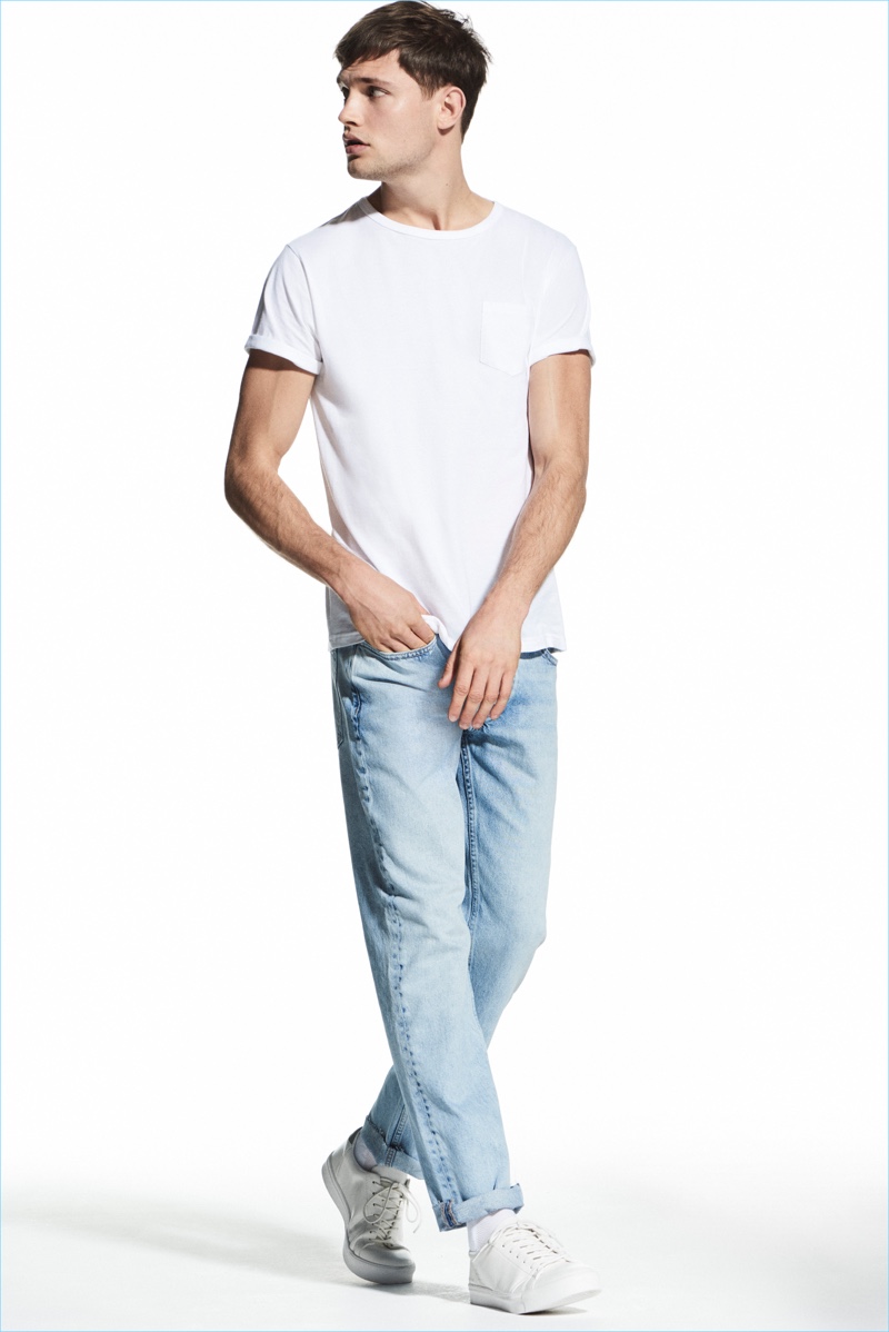 Embracing easy style, Stefan Pollman models a tee and denim jeans from River Island.