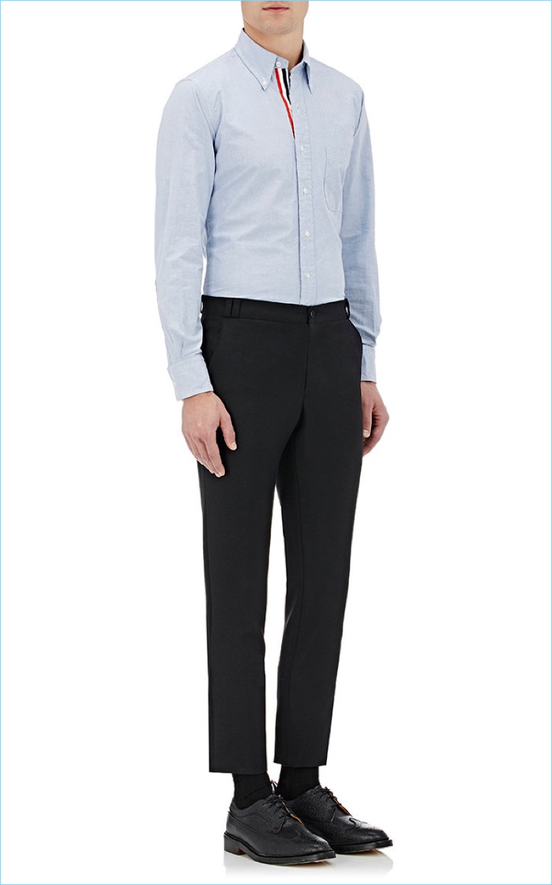 Barneys New York styles Thom Browne's blue oxford cloth shirt with a simple pair of cropped trousers and black dress shoes.