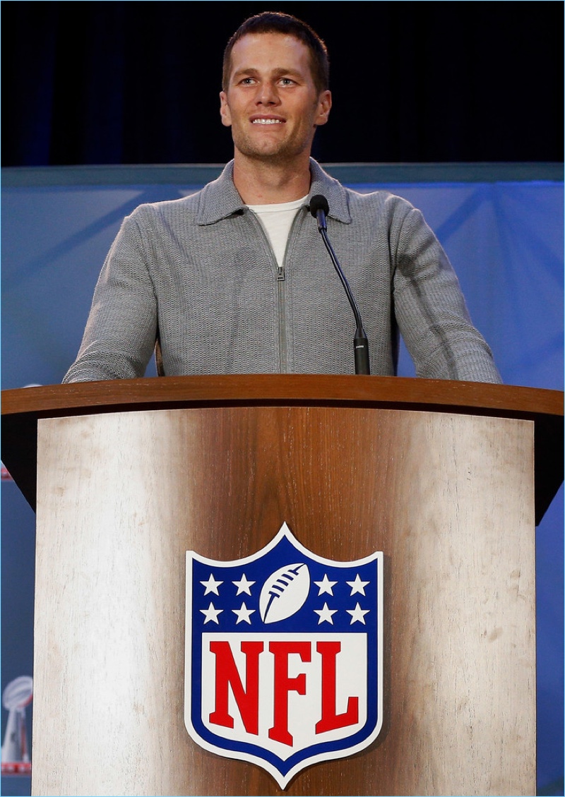 February 2017: Tom Brady dons a full-zip grey wool cardigan sweater by Tom Ford.