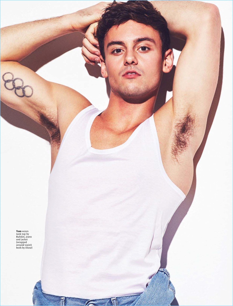 Showing off his biceps, Tom Daley wears a Rufskin tank with jeans and a jacket by Diesel.