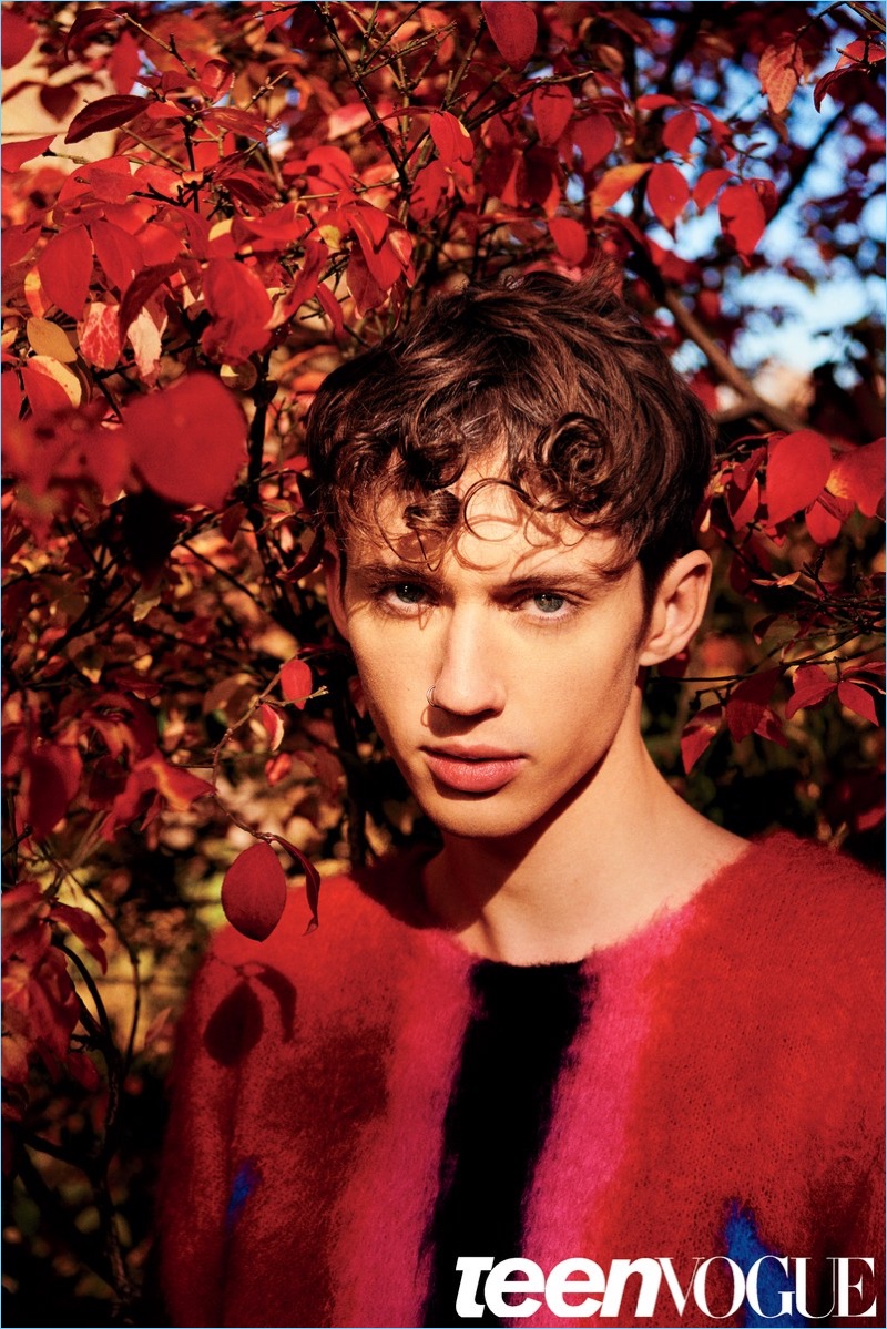 Singer Troye Sivan dons a red sweater by Louis Vuitton.