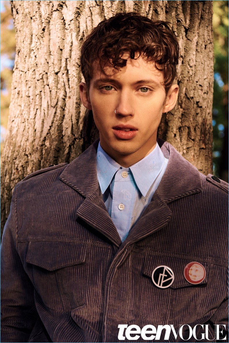 Appearing in a Teen Vogue photo shoot, Troye Sivan wears a shirt and corduroy jacket by Gosha Rubchinskiy.
