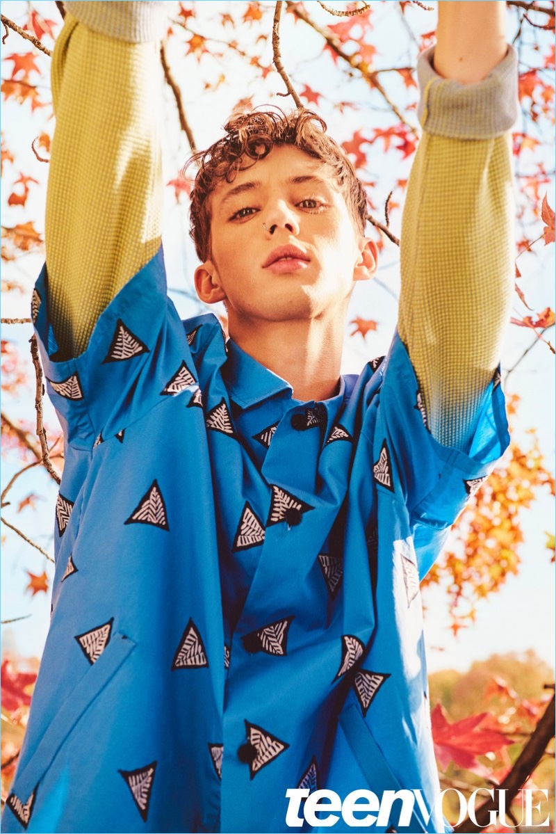 Going bold, Troye Sivan wears a sweater and shirt by Kenzo.