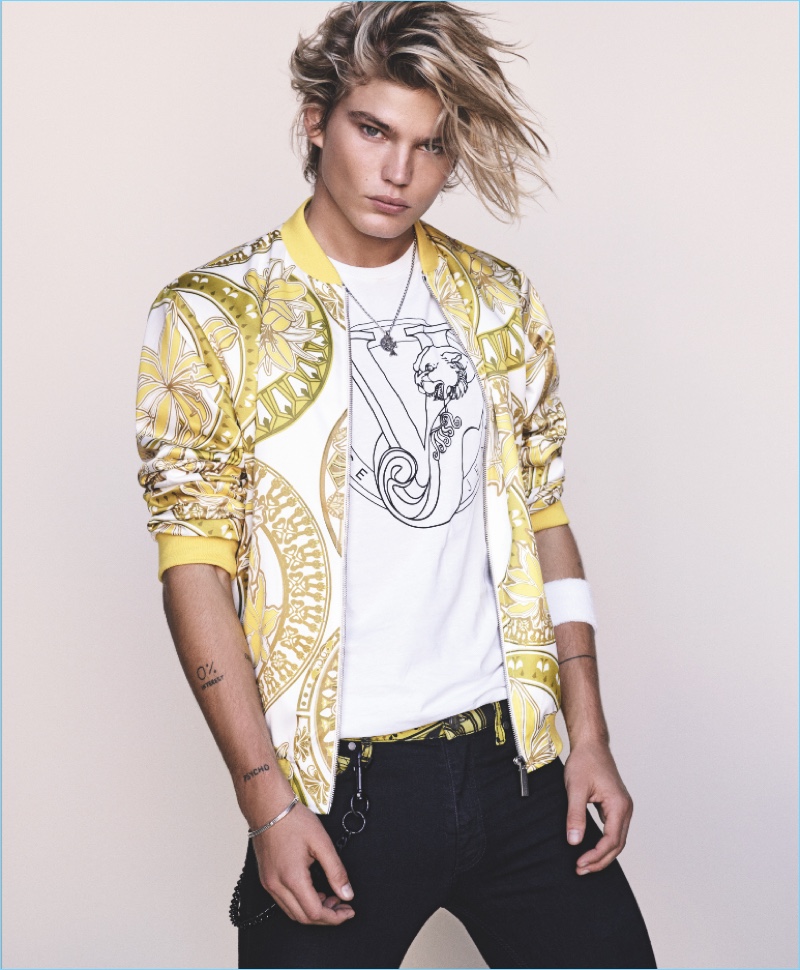 Australian model Jordan Barrrett wears a yellow printed bomber jacket for Versace Jeans’ spring-summer 2017 lookbook.