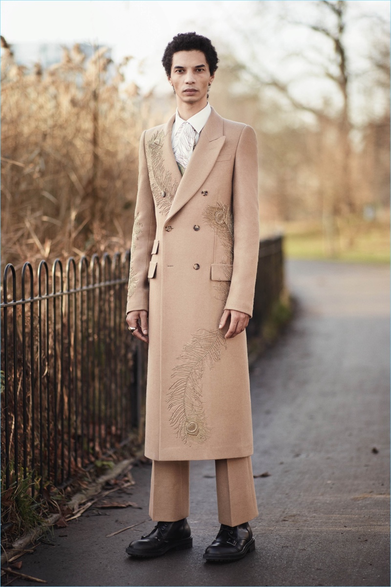 British brand Alexander McQueen commits to a camel hued story with a long double-breasted overcoat and pleated trousers.