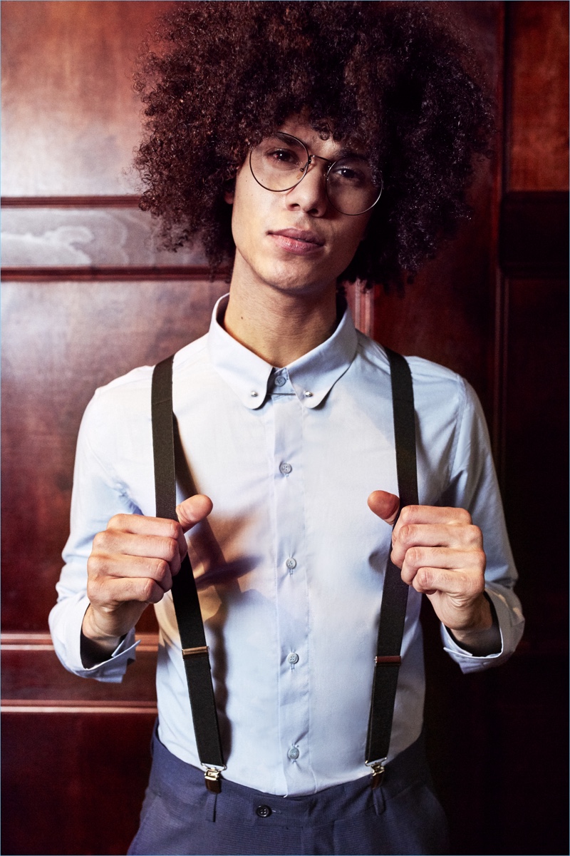 Wearing suspenders with a smart shirt and trousers, Bruno Fabre sports boohooMAN.