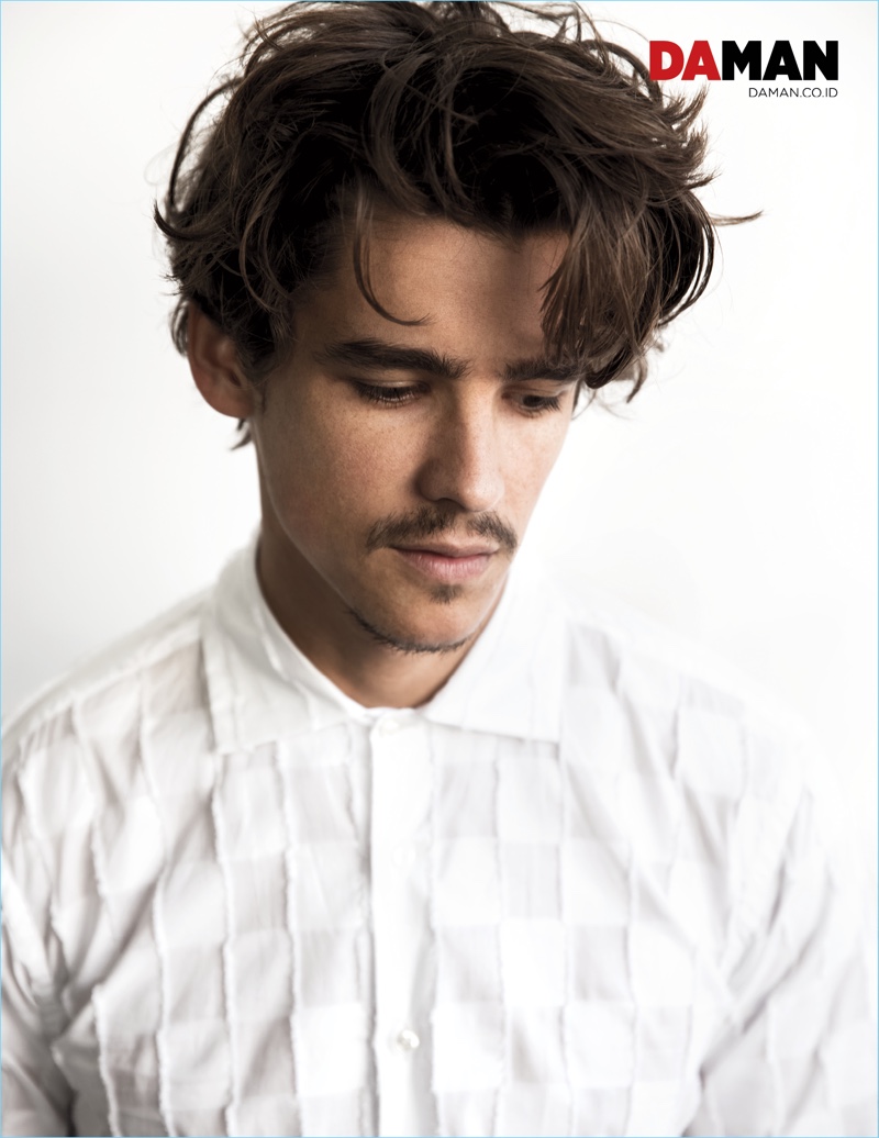 Actor Brenton Thwaites dons a white short-sleeve shirt by Etro.