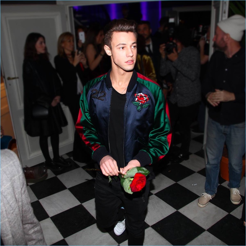 Cameron Dallas wears a Carolina Herrera bomber jacket at a party for 212 VIP.