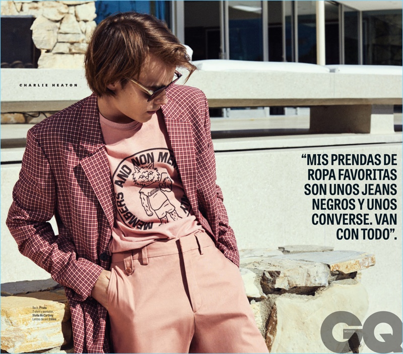 Starring in a GQ Style México photo shoot, Charlie Heaton wears a Prada coat with a Stella McCartney t-shirt and trousers. Heaton also dons Celine sunglasses.