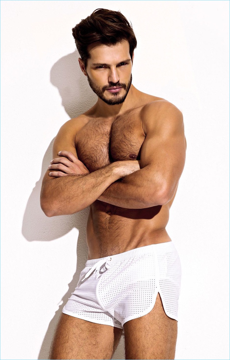 Brazilian model Diego Miguel wears Charlie by Matthew Zink's white Perforated Trainer swim shorts.