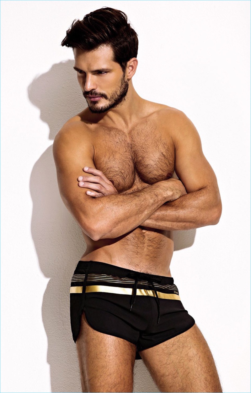 Going for a bold accent, Diego Miguel wears Charlie by Matthew Zink's black Sport Foil Trainer swim shorts.