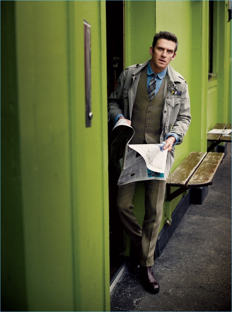 Actor Dan Stevens wears a vest and trousers by POLO Ralph Lauren. In exchange for a sport coat, Stevens dons a military jacket from the brand with Tom Ford boots.