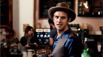 Dan Stevens Explores Dublin with GQ, Dons Waistcoats for Style Shoot Enjoying a warm beverage at The Fumbally in Dublin, Dan Stevens wears a HUGO Hugo Boss suit with a Visvim shirt, Stetson hat, and Timex watch.