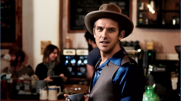 Enjoying a warm beverage at The Fumbally in Dublin, Dan Stevens wears a HUGO Hugo Boss suit with a Visvim shirt, Stetson hat, and Timex watch.