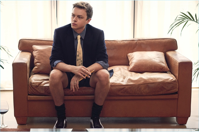 Losing his pants, Dane DeHaan wears a Giorgio Armani blazer and shirt with E.Tautz shorts, Gucci socks, and Church's lace-up shoes.