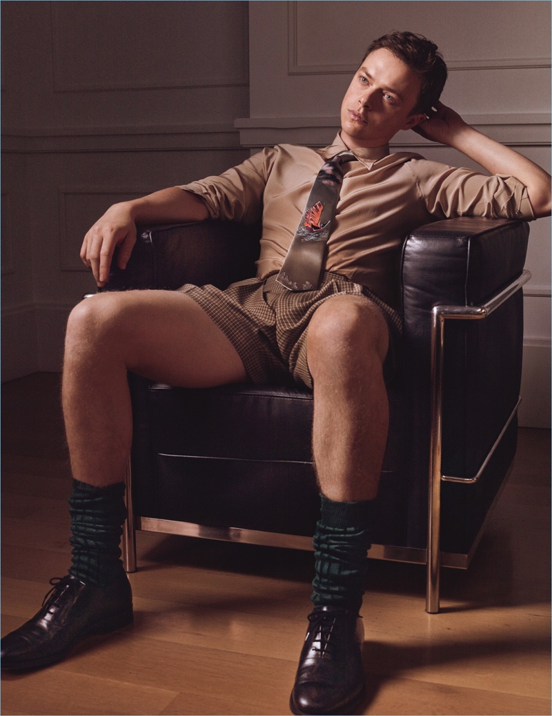 Serving a lot of leg, Dane DeHaan wears a Jeffrey Rüdes shirt with E.Tautz shorts, Gucci socks, and Church's dress shoes.