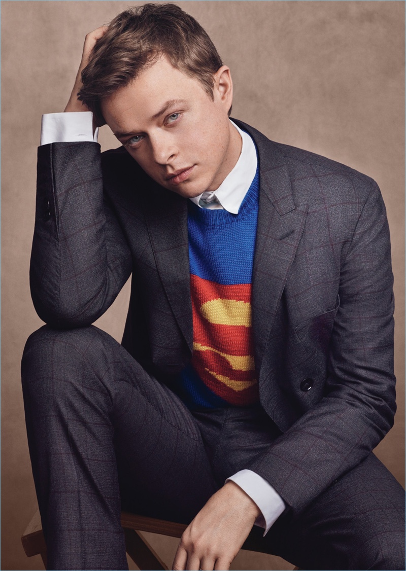 Appearing in a photo shoot for W magazine, Dane DeHaan wears a BOSS suit and shirt with a vintage sweater and tie.