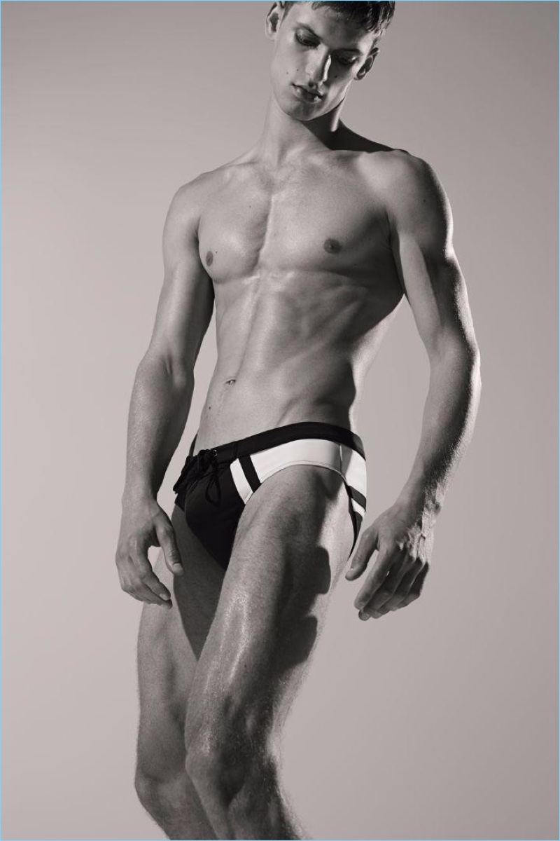 Model David Trulik wears a black and white swimsuit for Dirk Bikkembergs' spring-summer 2017 campaign.