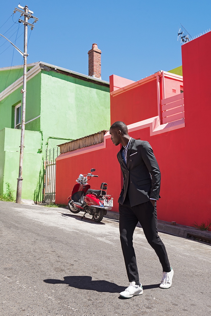 Gauderic wears suit Hugo Boss, striped shirt Chevignon, and shoes Prince.