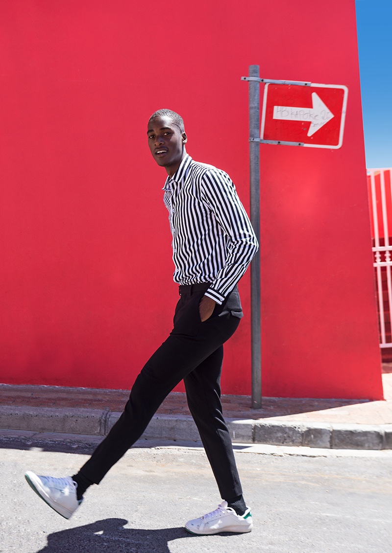 Gauderic wears striped shirt Chevignon, trousers Paul Smith, and shoes Prince.