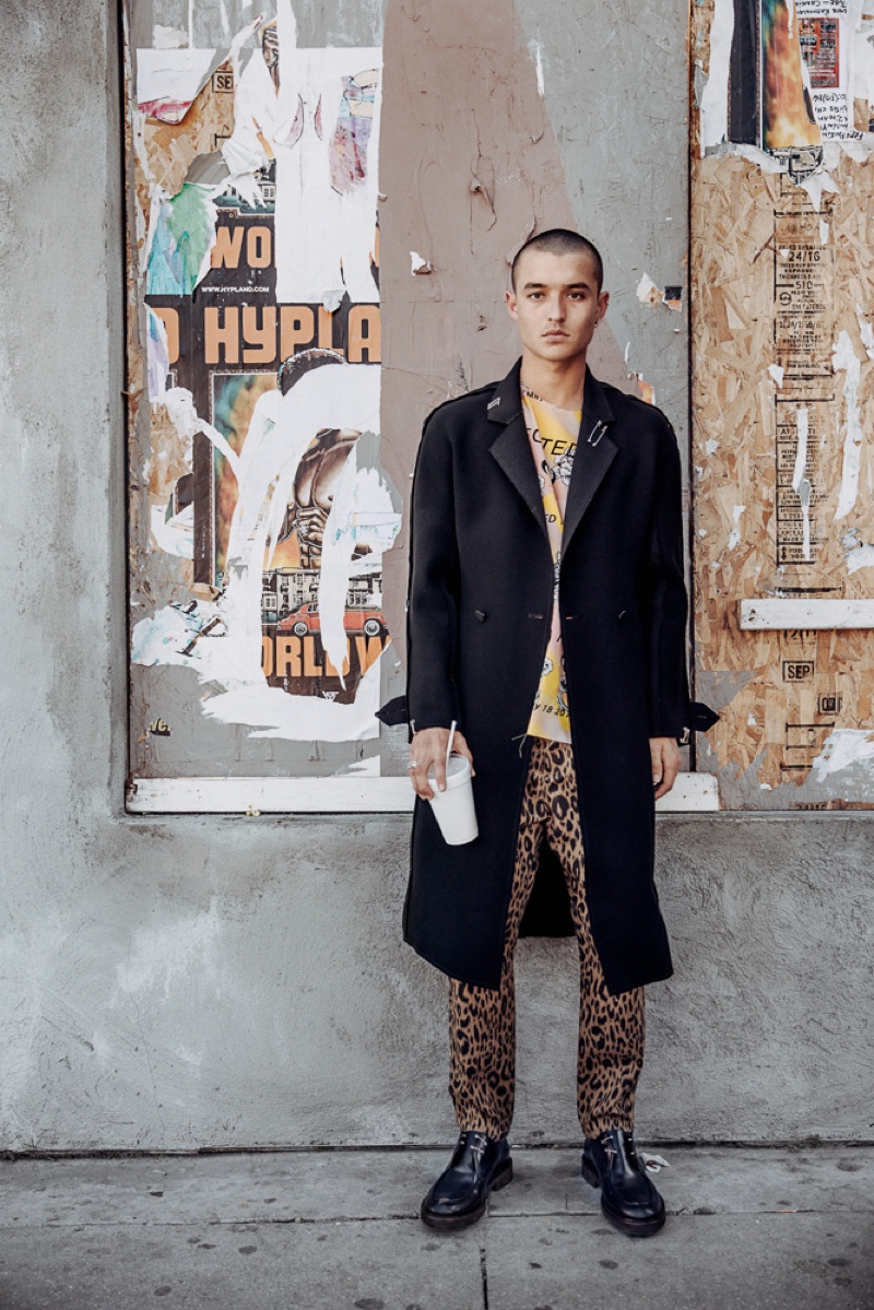 Kaleb wears coat J.W. Anderson, shirt Devon Halfnight LeFlyufy, leopard print trousers Robert Geller, and boots A.P.C.