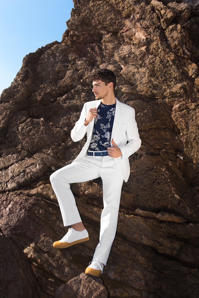 Mario wears white suit GUESS, floral print t-shirt H&M, belt Armani, and shoes G-Star Raw.