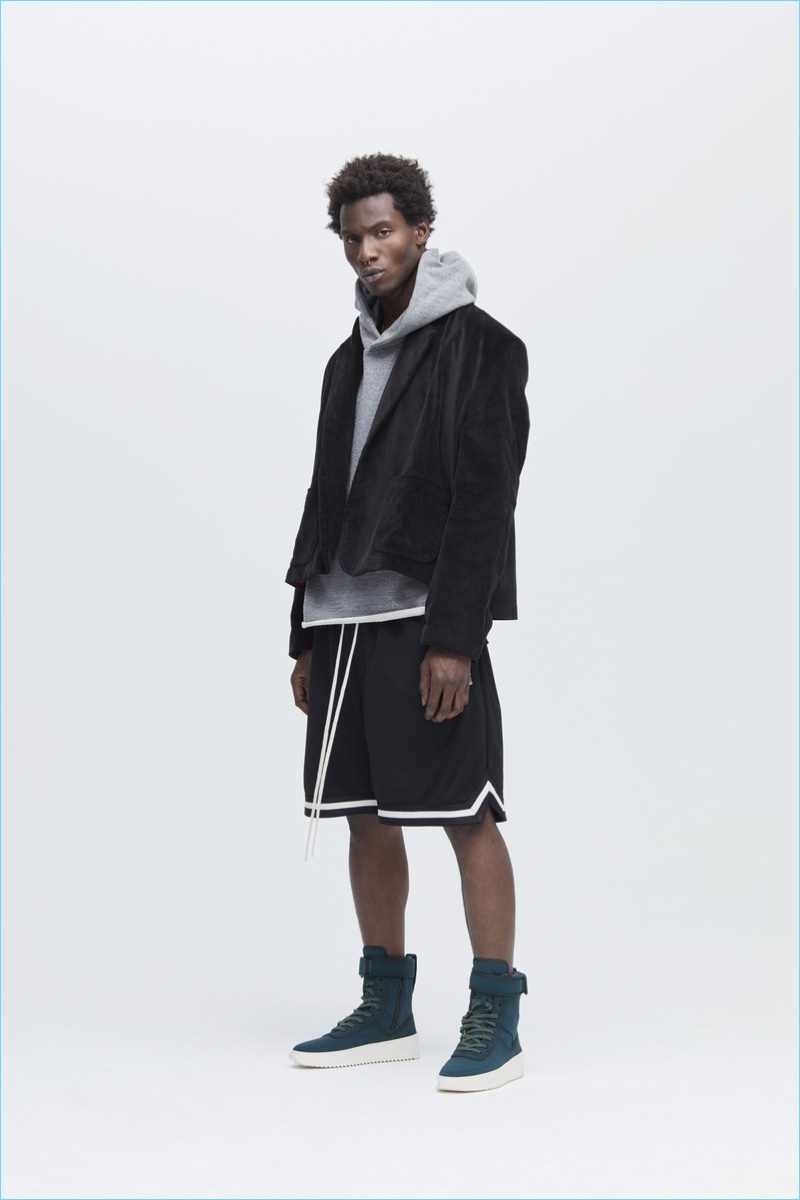 Adonis Bosso wears a cropped jacket with a hoodie, shorts and hi-top sneakers from Fear of God's fall-winter 2017 collection.