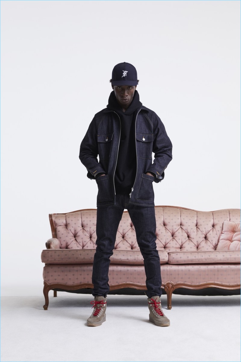 Starring in Fear of God's fall-winter 2017 lookbook, Adonis Bosso rocks a denim jacket with a hoodie, jeans, and boots.