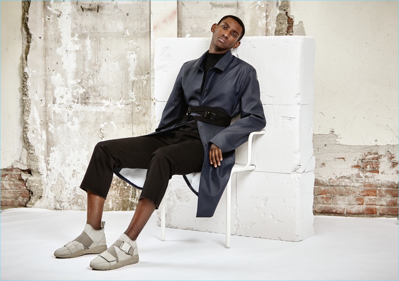 Myles Dominique wears Filling Pieces' Runner Mid Ballistic Strap sneakers in grey.