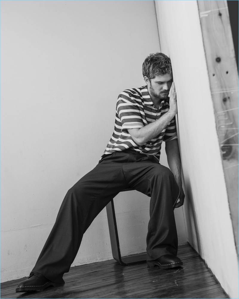 Actor Finn Jones sports a striped Exinfinitas shirt with Woodhouse pants, and shoes by Dr Martens x Engineered Garments.