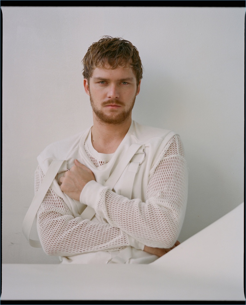 Sporting white, Finn Jones wears a Private Policy vest and a long-sleeve mesh shirt by Off-White.