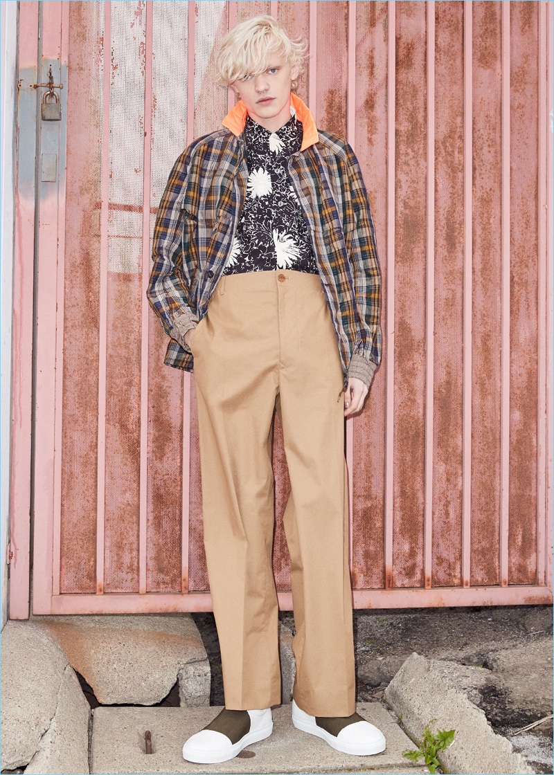 Front and center, Turner Barbur wears a Kolor check jacket with a Junya Watanabe cupra voile print shirt. Turner also sports Stella McCartney trousers with Givenchy leather skate elastic sneakers.