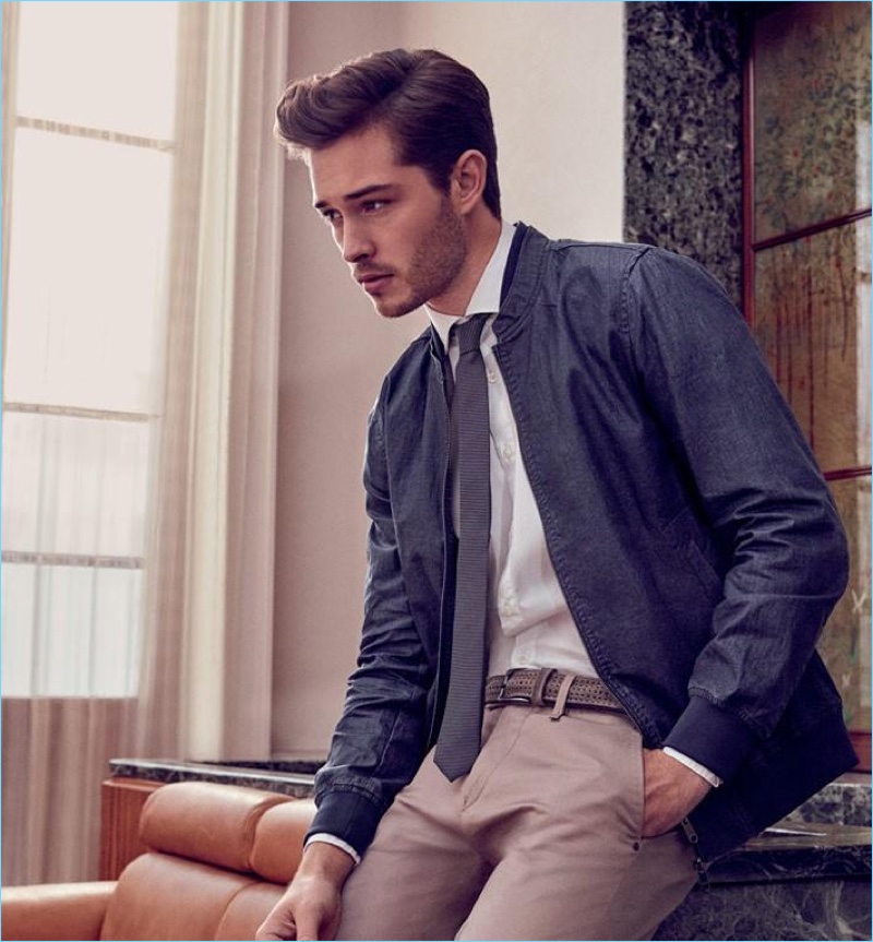 Tapping into a smart aesthetic, Francisco Lachowski wears a bomber jacket with a shirt and tie.