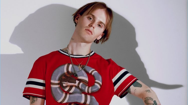 Emerik Derome makes a bold statement in a graphic snake print top from Gucci.