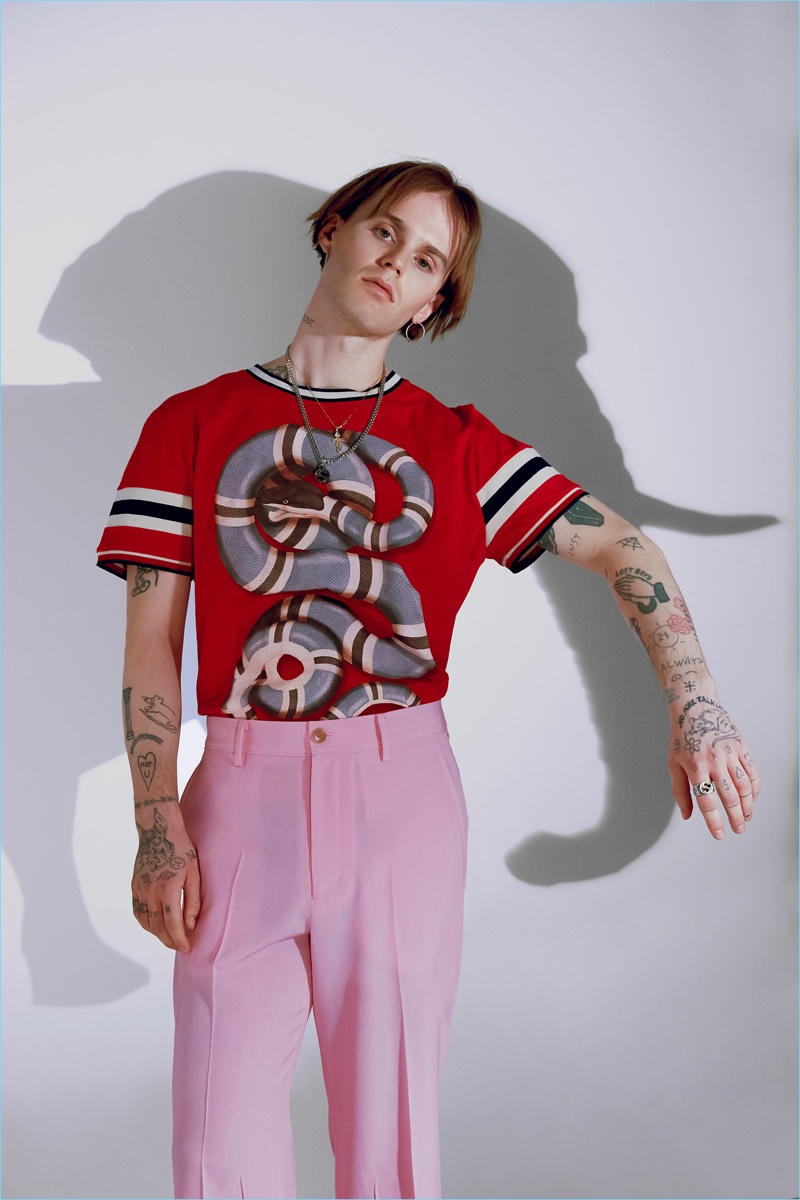 Emerik Derome makes a bold statement in a graphic snake print top from Gucci.