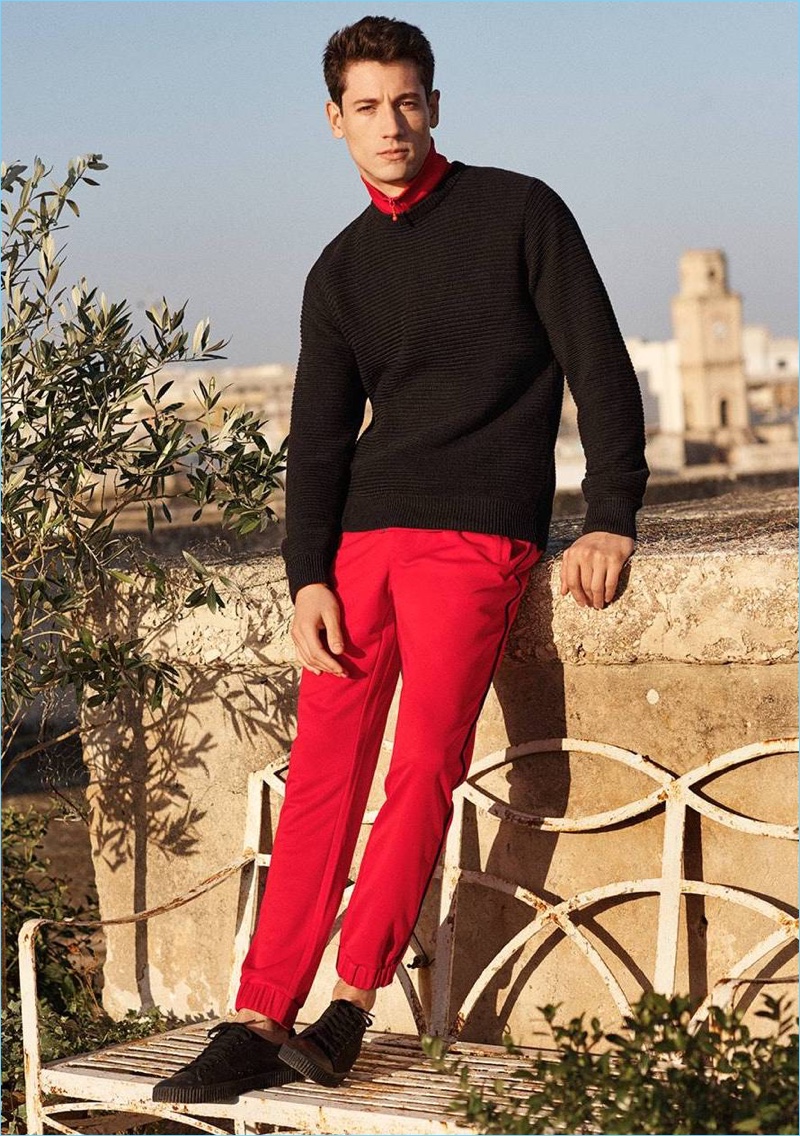 Going sporty, Nicolas Ripoll wears a sweater, track jacket, joggers, and shoes from H&M.