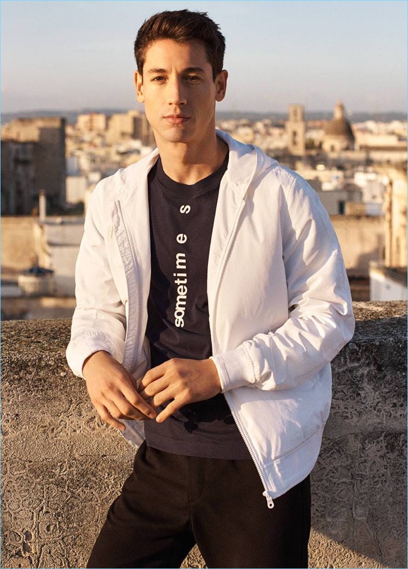 Model Nicolas Ripoll wears a t-shirt, windproof jacket, and cargo pants from H&M.