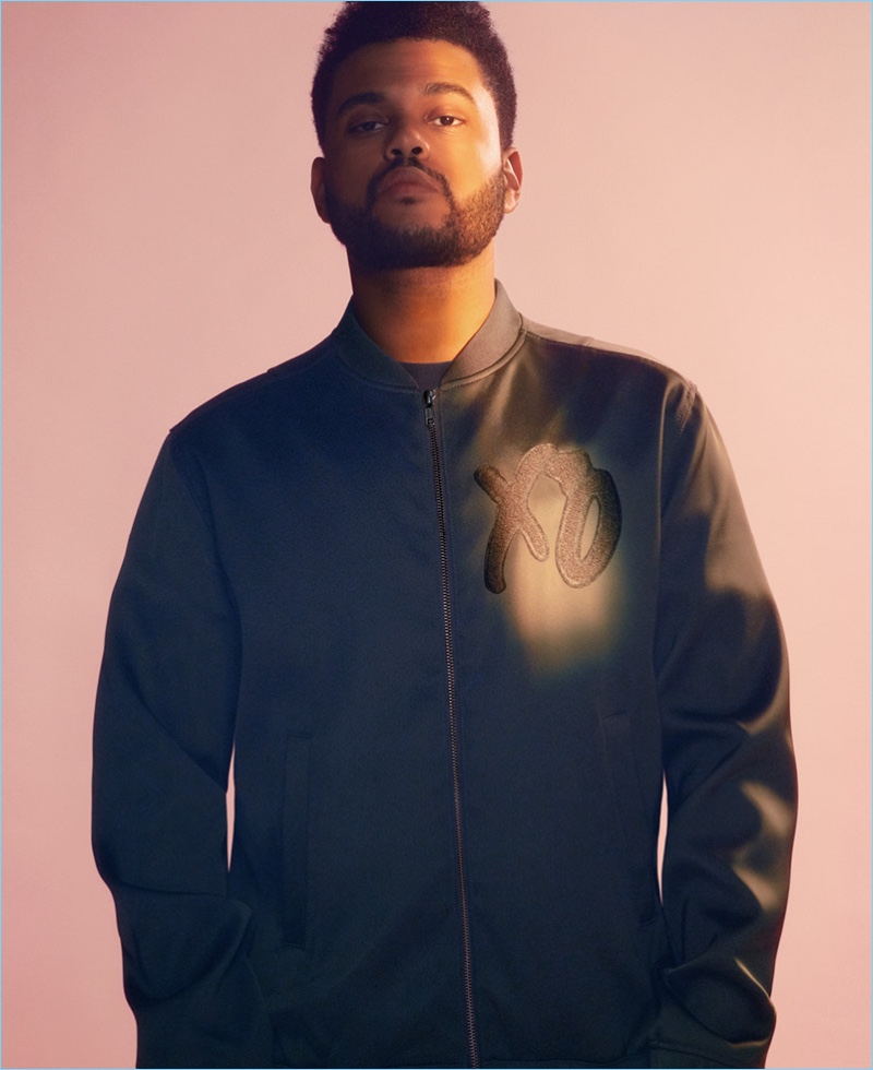 Front and center, The Weeknd wears a bomber jacket with an XO on the chest.