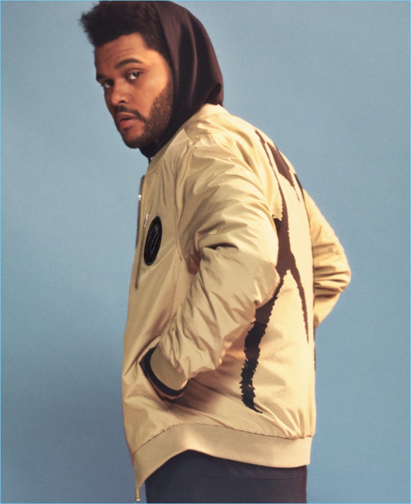 Singer The Weeknd sports a tan bomber jacket from H&M's Spring Icons.