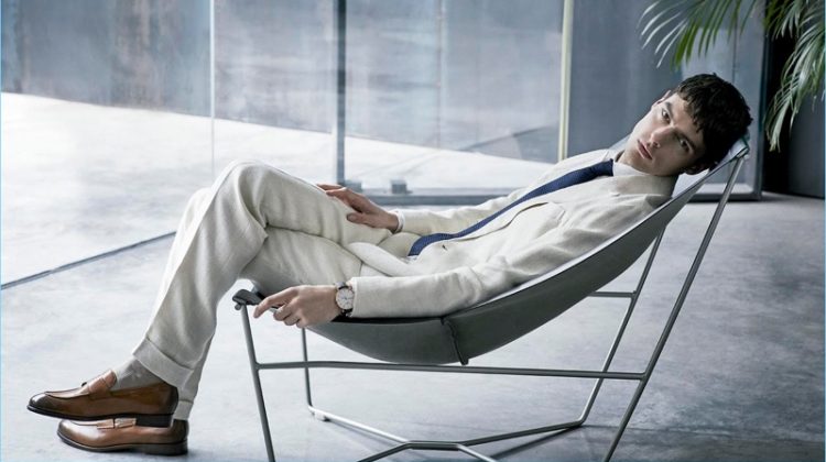 Model Hannes Gobeyn relaxes in a POLO Ralph Lauren double-breasted suit. Hannes also wears a linen shirt by Adolfo Dominguez with a Canali tie and Ermenegildo Zegna.