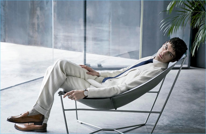 Model Hannes Gobeyn relaxes in a POLO Ralph Lauren double-breasted suit. Hannes also wears a linen shirt by Adolfo Dominguez with a Canali tie and Ermenegildo Zegna.