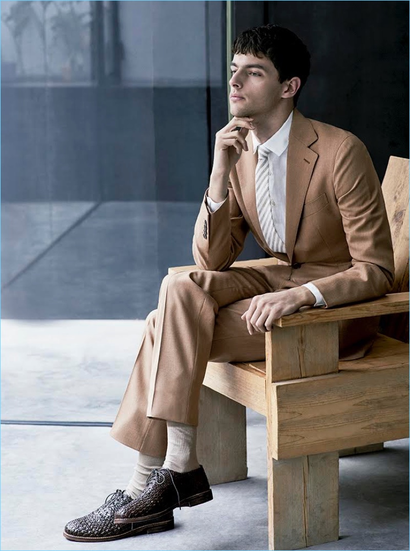 Making a brown statement, Hannes Gobeyn sports a Caruso suit with a Sandro shirt. Hannes' look is complete with Adolfo Dominguez shoes.