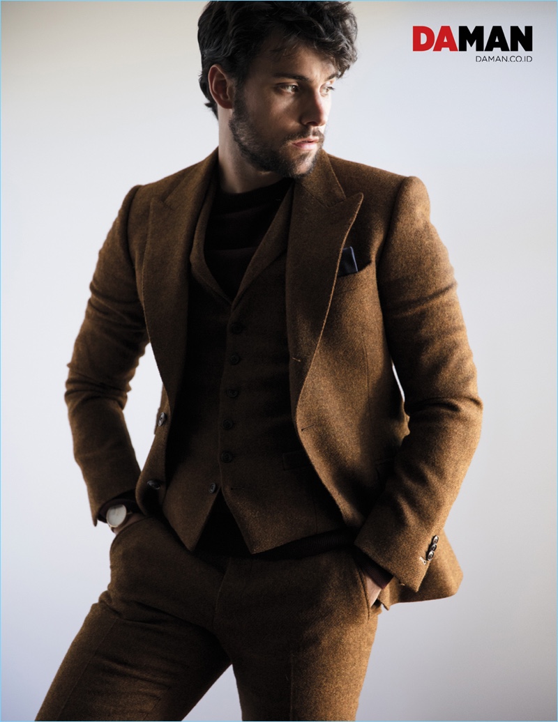 Donning a brown Klein Epstein & Parker suit, Jack Falahee also wears a Calvin Klein sweater.