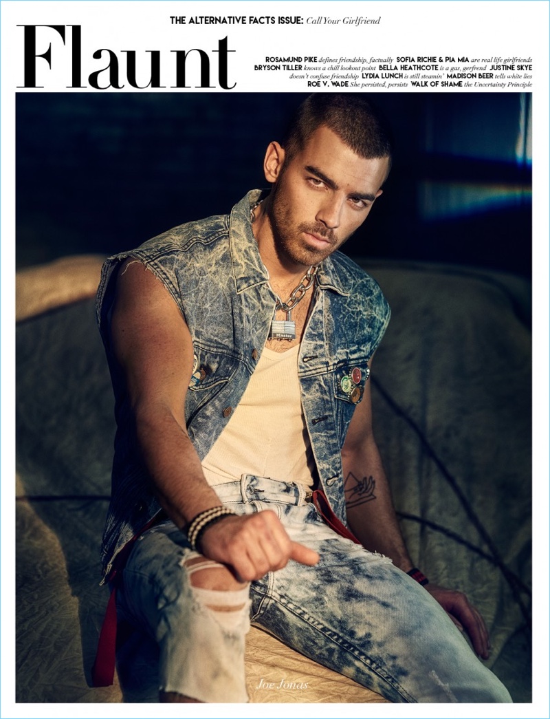 Joe Jonas covers the latest issue of Flaunt magazine. The singer sports a vintage GUESS vest with a tank and suspenders. Jonas also sports ripped GUESS jeans.