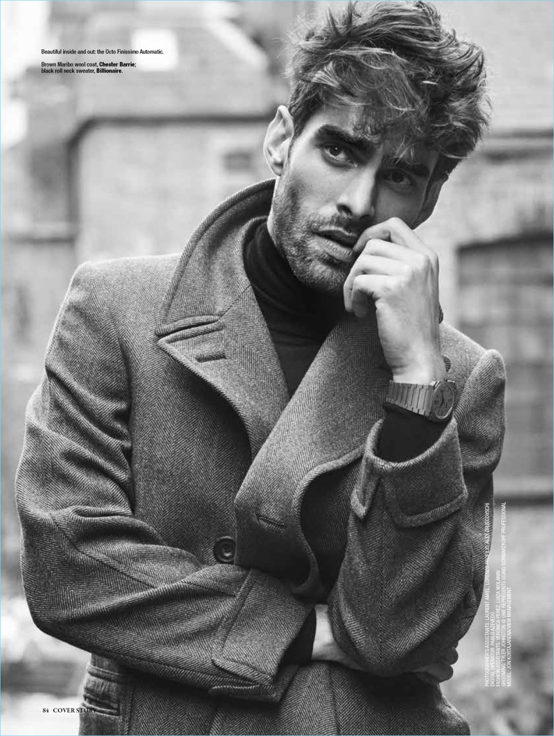 Spanish model Jon Kortajarena dons a Chester Barrie coat with a Billionaire sweater.