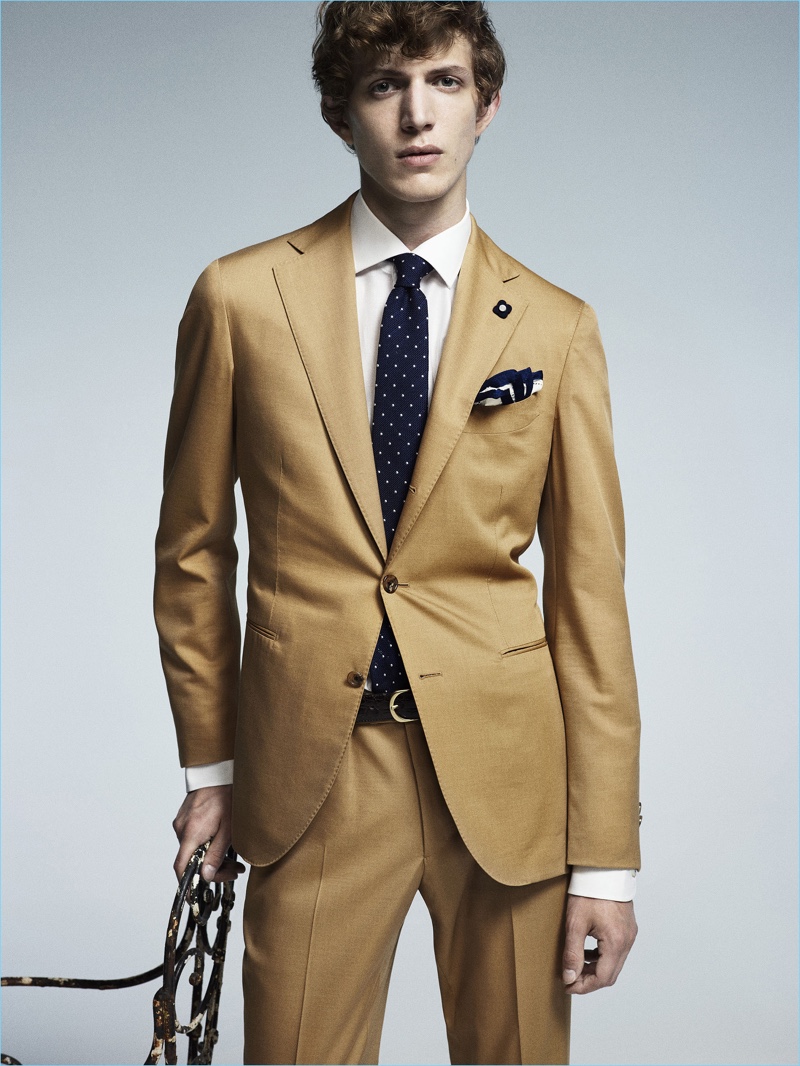 Xavier Buestel dons a camel hued suit from Lardini's spring-summer 2017 collection. » Tailoring Revisited: Lardini Does Military Style for Spring '17 Collection Xavier Buestel dons a camel hued suit from Lardini's spring-summer 2017 collection.