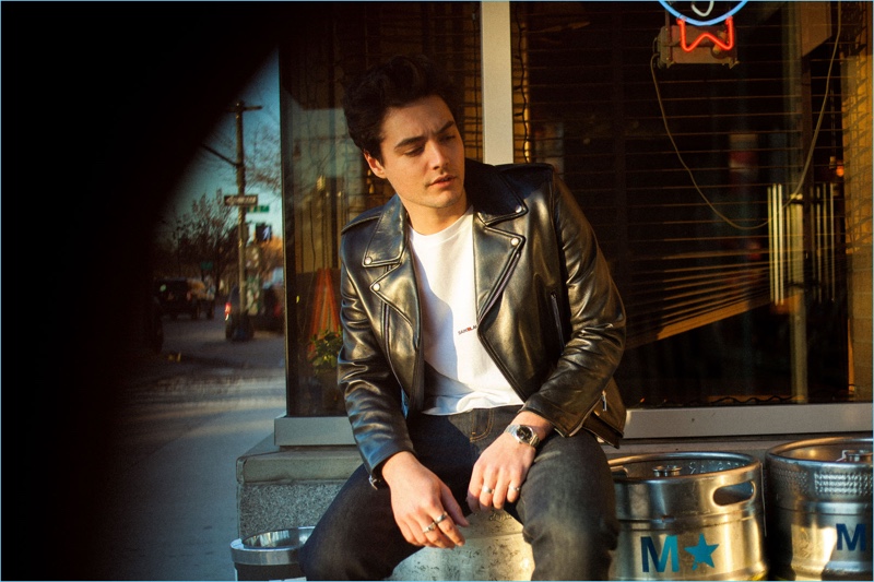 Playing it cool, Levi Dylan rocks a leather biker jacket by Saint Laurent.