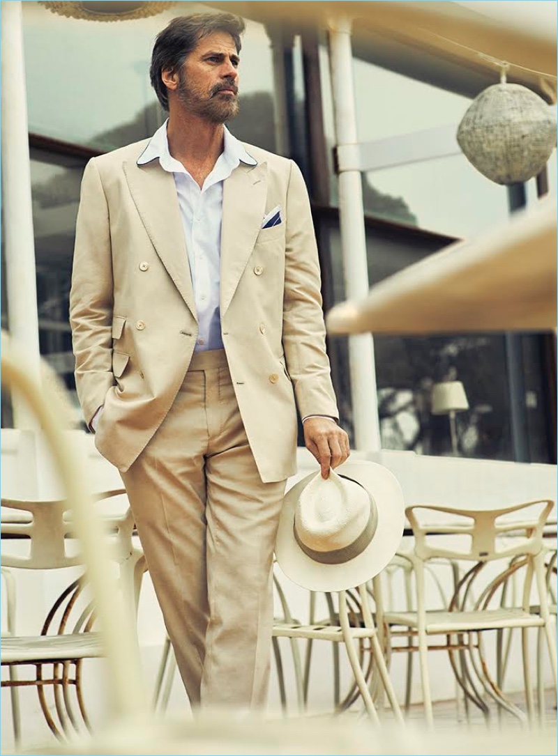 Model Mark Vanderloo embraces neutrals, wearing a double-breasted Massimo Dutti suit with a Panama hat by Harmont & Blaine.