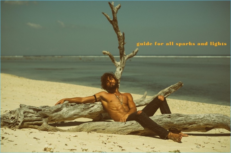 Going shirtless in ripped jeans, Marlon Teixeira is pictured on the beach.