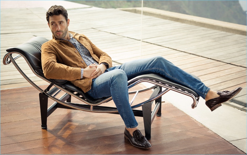 Relaxing in a brown suede jacket and denim jeans, Noah Mills stars in Pedro del Hierro's spring-summer 2017 campaign.